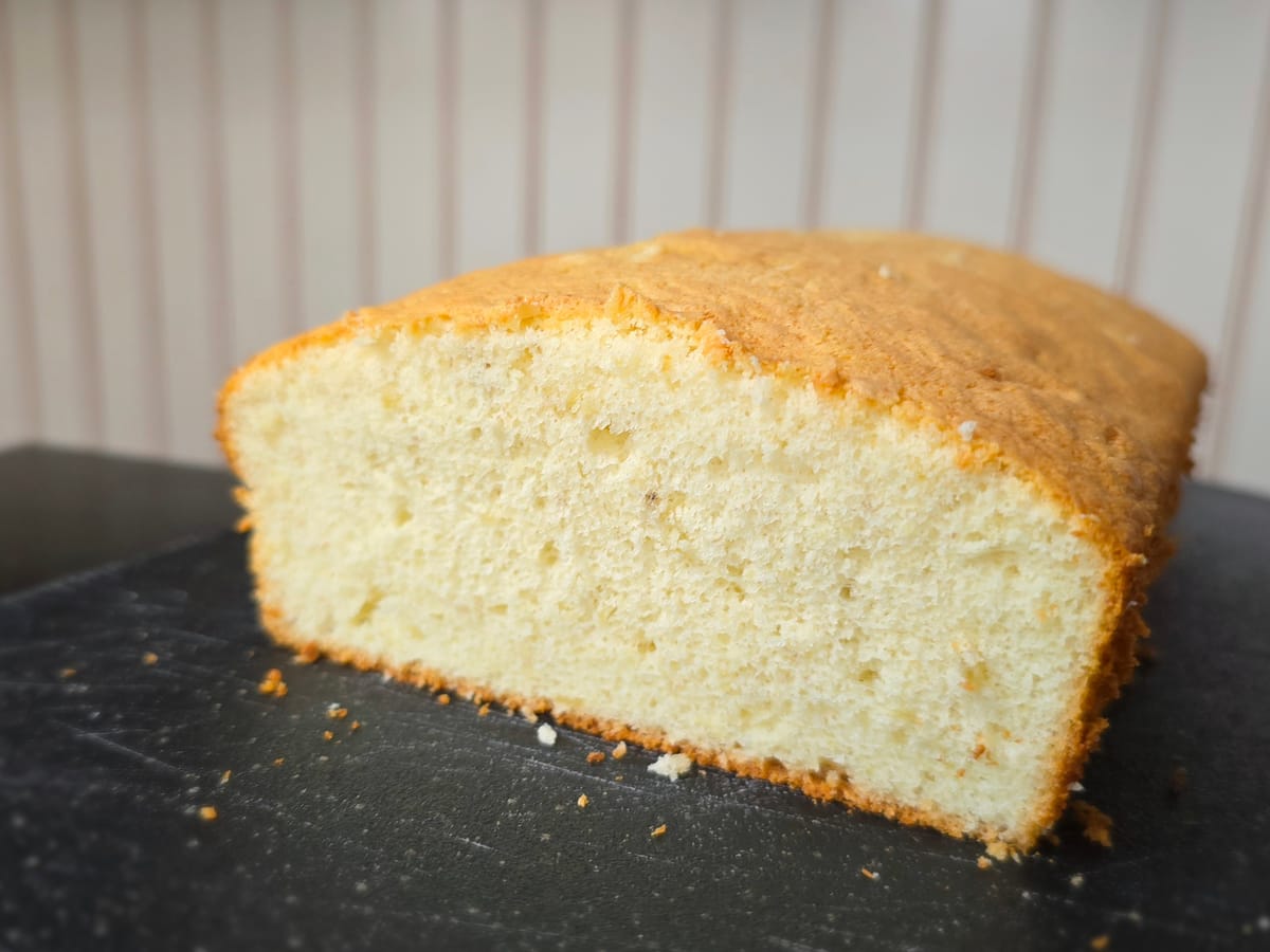Golden-brown Japanese Banana Chiffon Castella loaf with optional toasted nut and brown sugar topping, showing light fluffy crumb structure