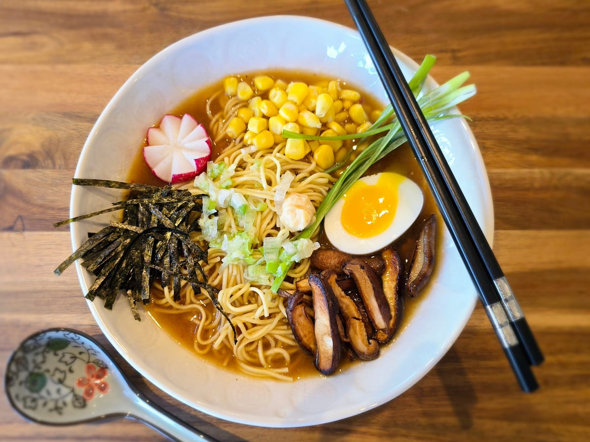 Bowl of authentic chintan ramen with clear broth, tender noodles, soft-boiled egg, and traditional Japanese toppings