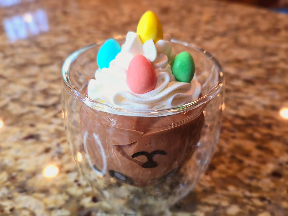 Creamy chocolate pudding in a glass bowl, rich dark chocolate color, smooth and glossy texture