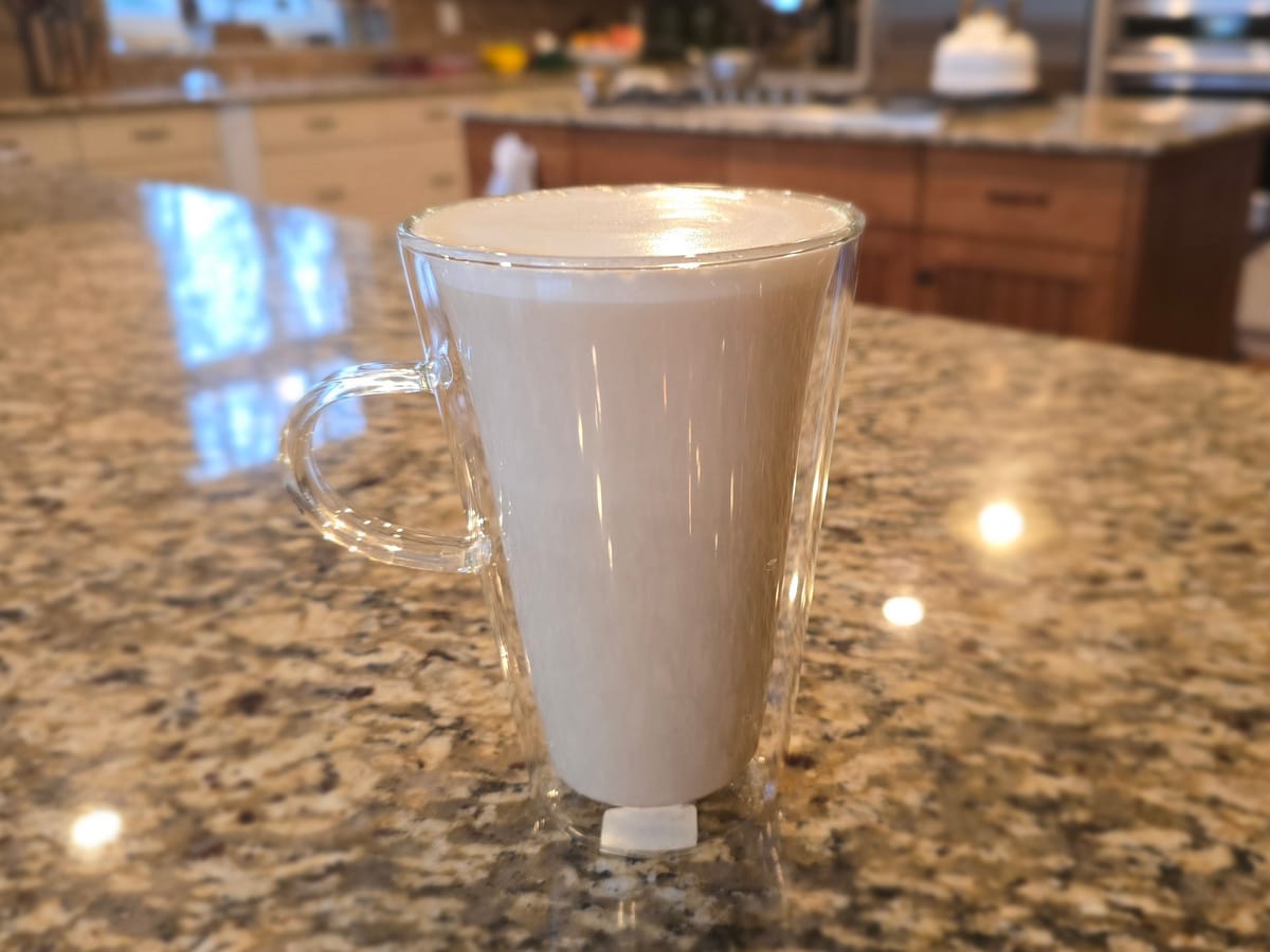 Cozy Maple London Fog latte in a ceramic mug with steamed milk foam, Earl Grey tea, and maple syrup