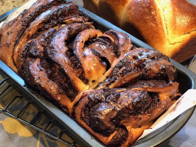 Ultimate chocolate babka loaf with rich chocolate swirls throughout soft, pillowy bread, sliced to show interior spiral pattern