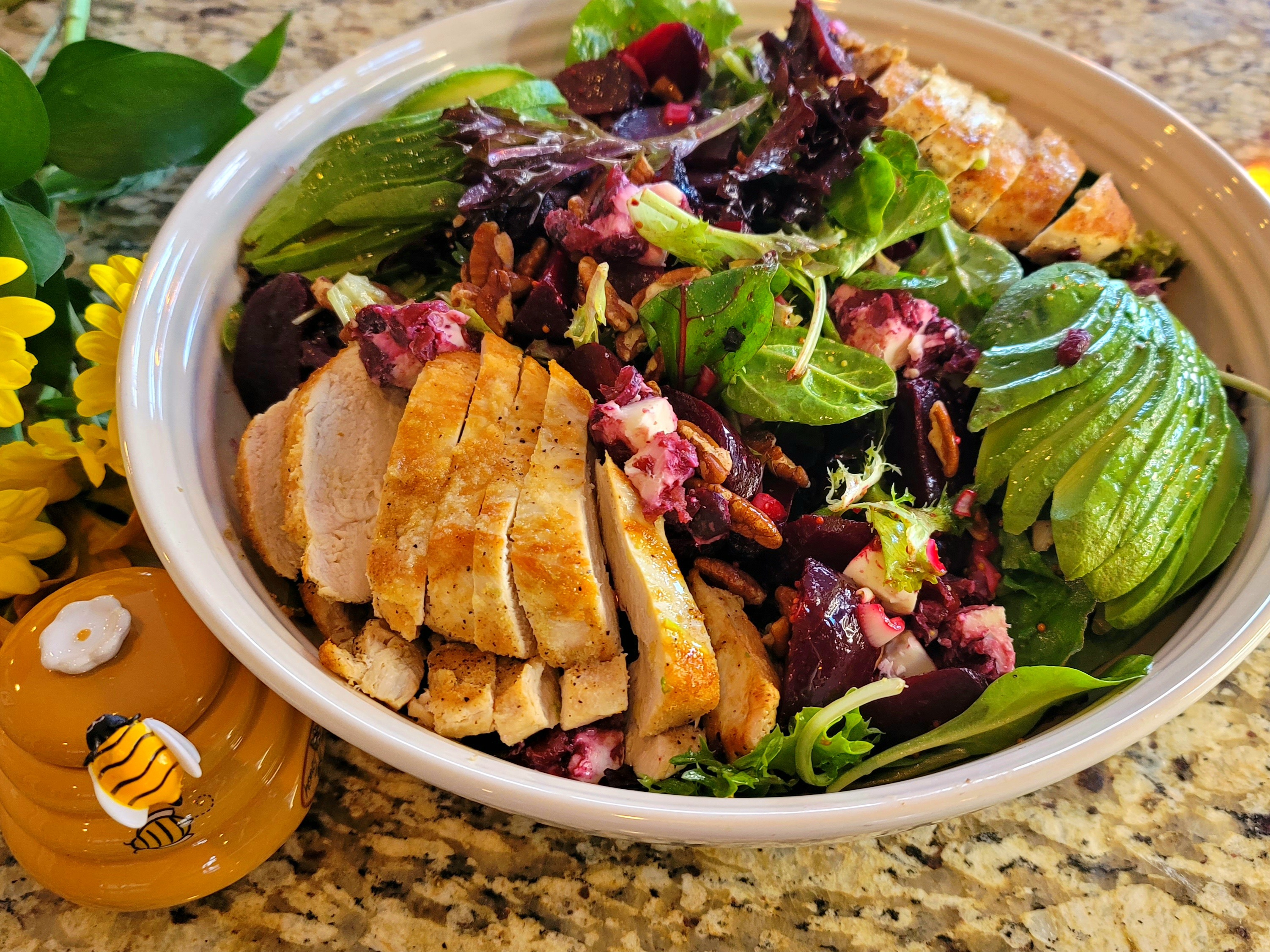 Golden-brown oven-baked chicken breasts on a white plate with herbs and garnish